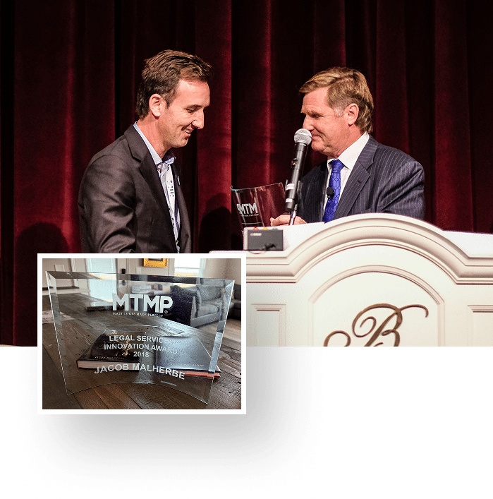 Jacob Malherbe receiving the Mass Torts Made Perfect Legal Services Innovation Award from Mike Papantonio, 2018, with the engraved glass award shown inset
